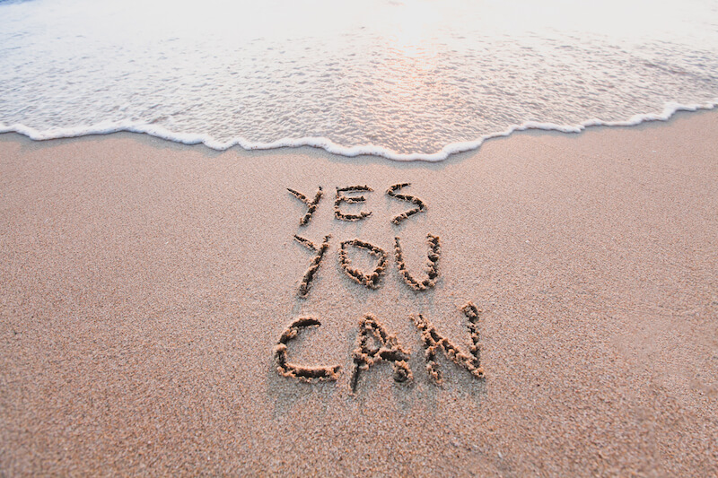 Inspirational message yes you can recover from tinnitus written on the beach